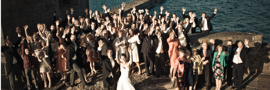 A group of people waving at a wedding in Guernsey